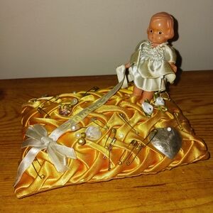 Beautiful collectible vintage doll on pin cushion